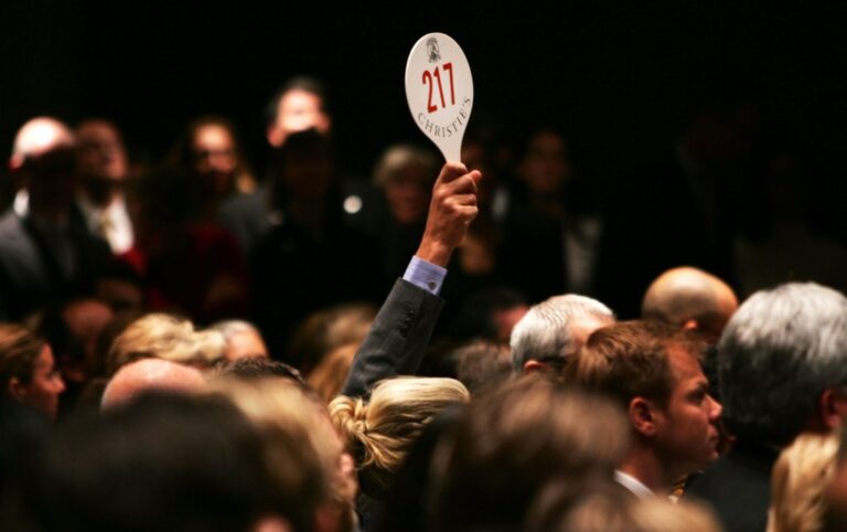 NEW YORK - NOVEMBER 15:  A man holds his hand up while bidding on a work of art inside the auction house Christie's during the Post-War and contemporary Art sale November 15, 2006 in New York City. Christie's estimates that works by Warhol, Willem de Kooning, Roy Lichtenstein and others could go for up to $220 million in what the auction house says may be the most valuable post-World War II and contemporary art auction in history. Warhol's "Mao" portrait from 1972 went for over 17 million, setting an all time record for the artist.  (Photo by Spencer Platt/Getty Images)